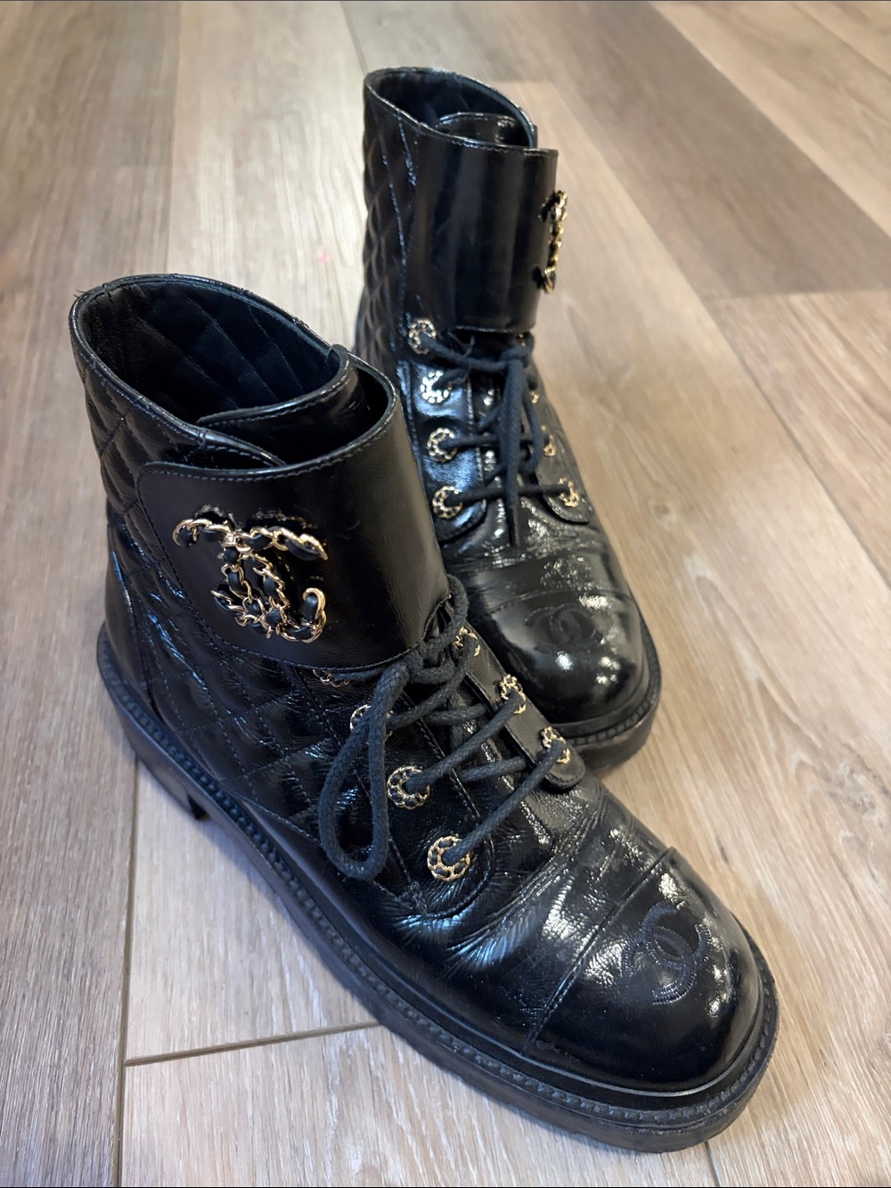 CHANEL Black Quilted Lace-Up Combat Boots with Gold CC Accents